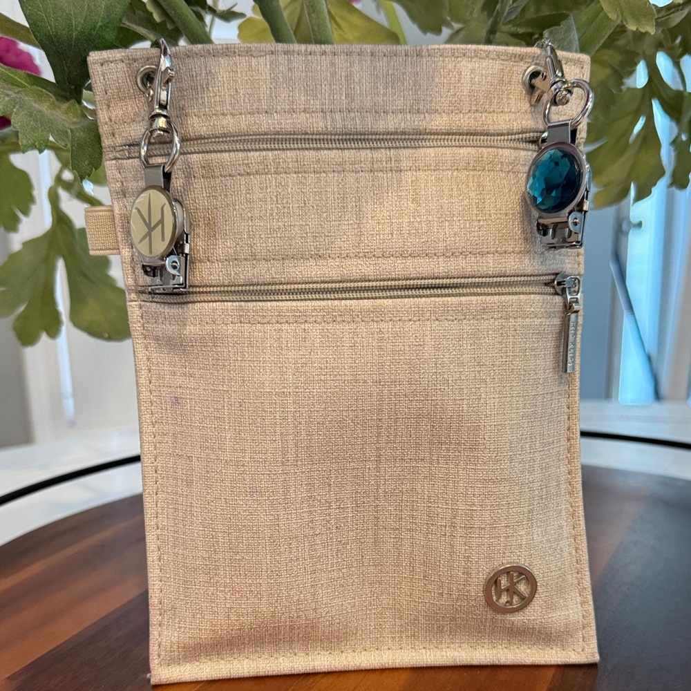 Beige Crossbody/Saddle Bag with Silver Accents. Has clips to add to belt.